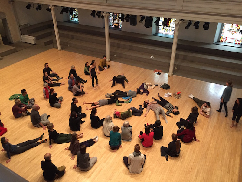 Participants in the Movement Delicious Workshop witness other movers lie on the backs and revel in the simplicity of the movement